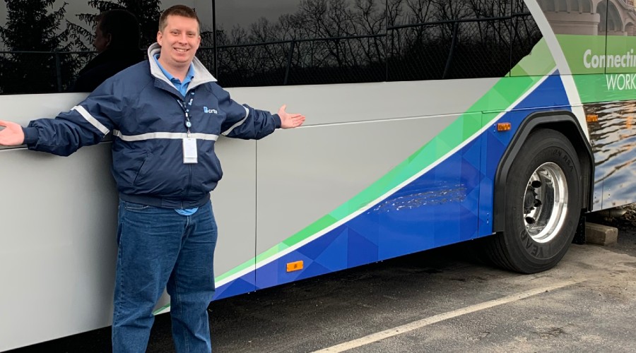 Dale Savage standing in front of a BCTRA bus