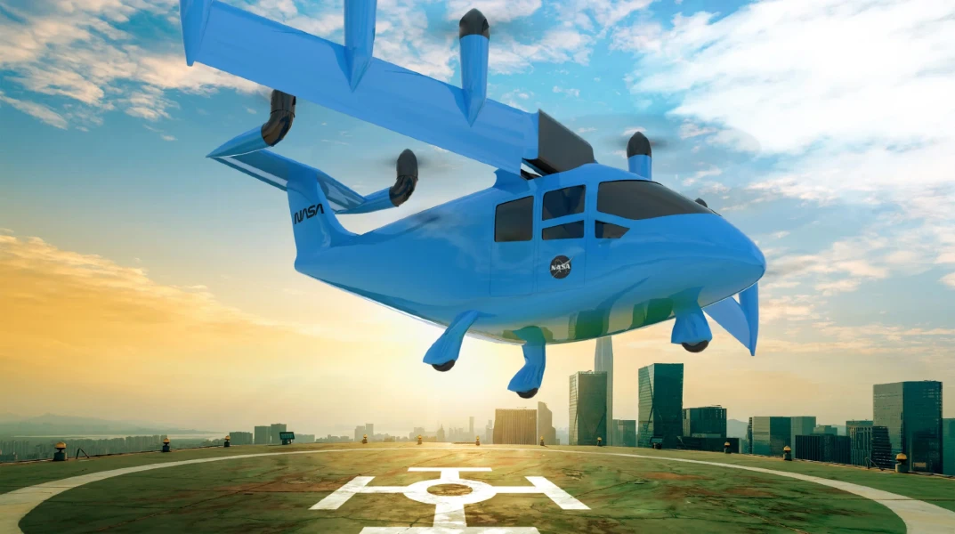 A blue helicopter flies down to a landing pad, there is an urban landscape and skyscrapers in the distance.