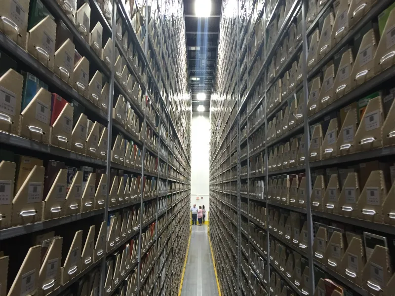Sword interior photo of large metal shelfing holding files.