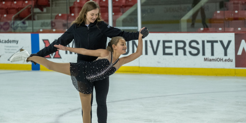 instructor teaching figure skater how to spiral