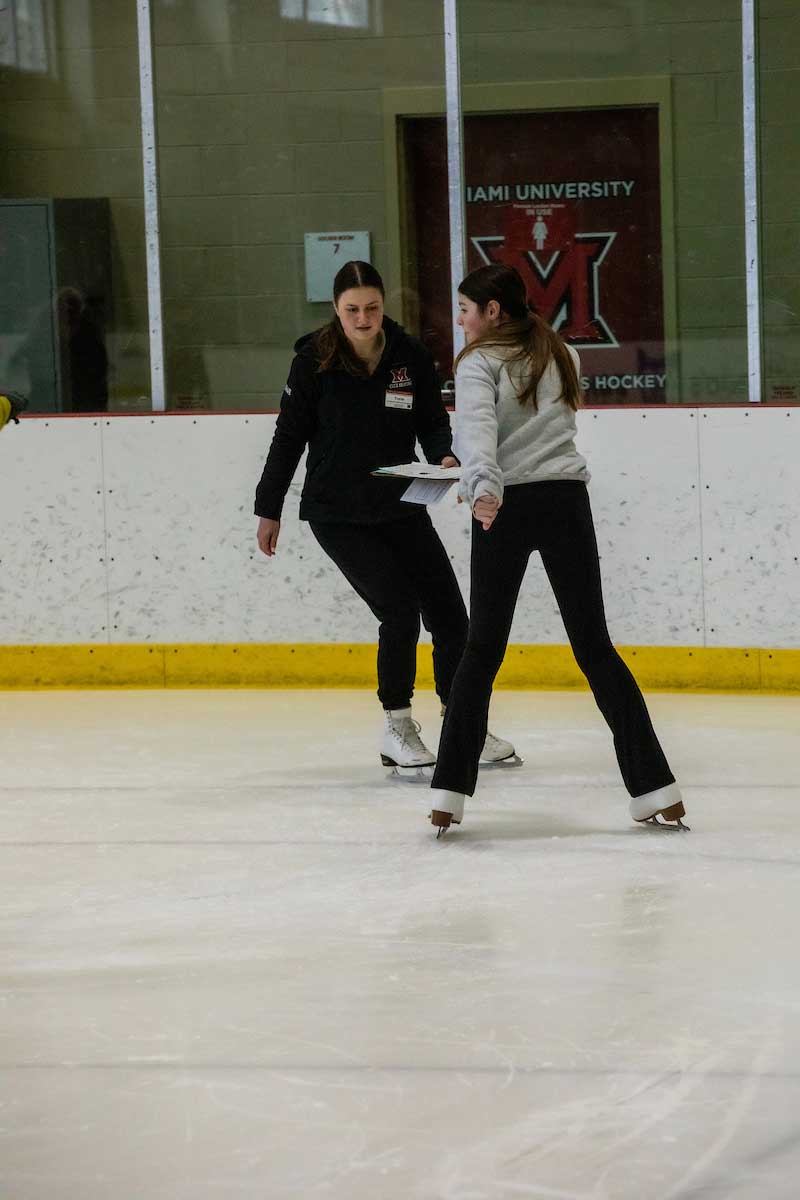 ice skating trainer working with a skater during private lessons