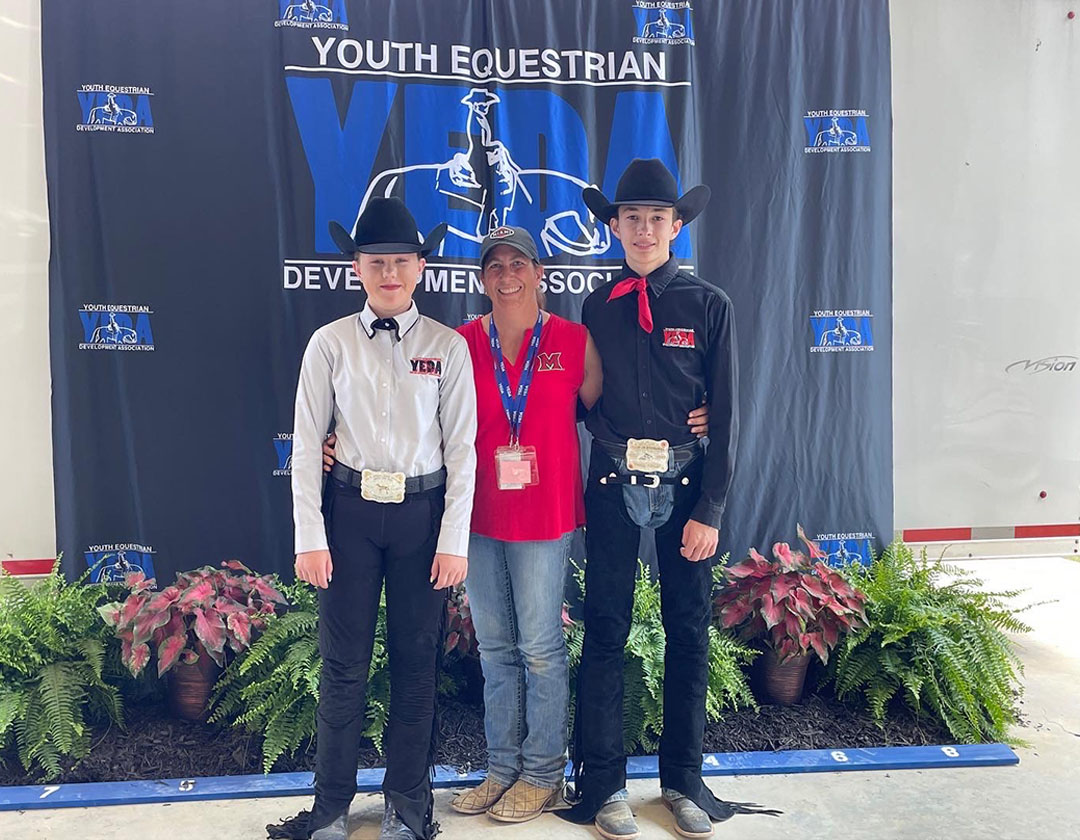 Youth Equestrian Team members standing at the podium winning awards