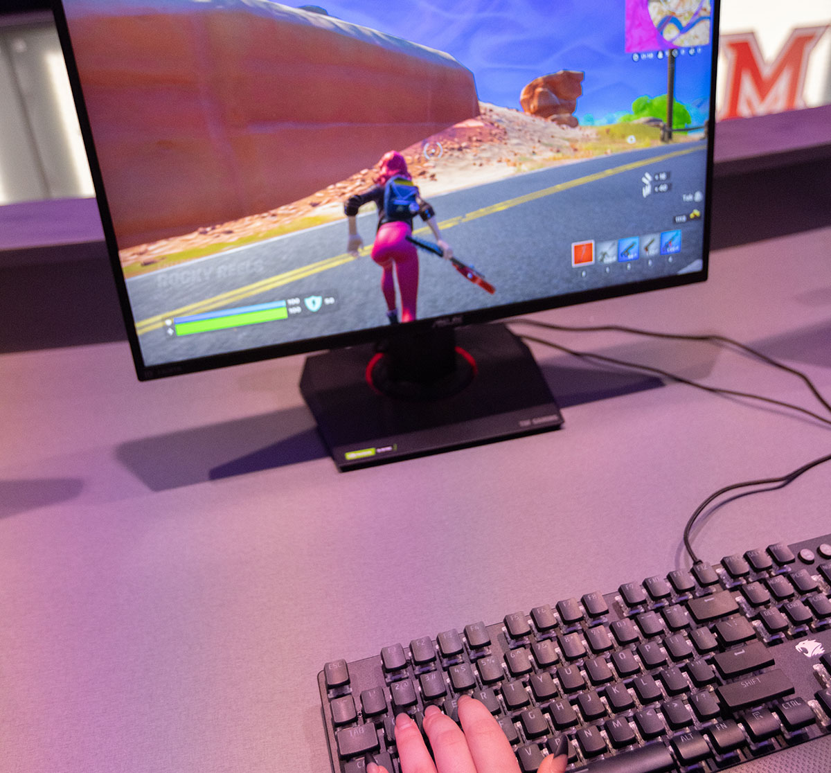 Person playing a video game on a computer with a keyboard