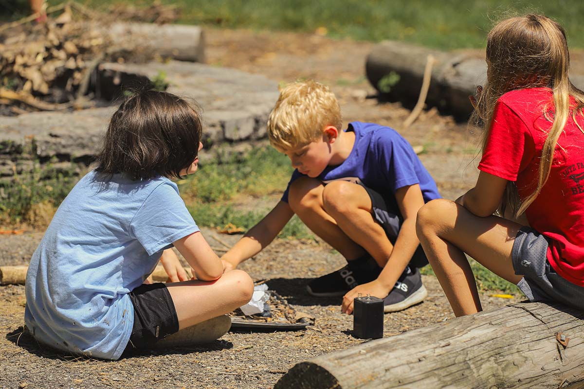 children learning how to make a fire