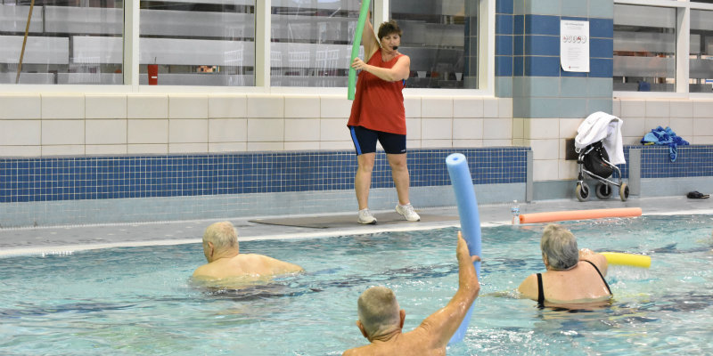 Community members taking a water fitness class