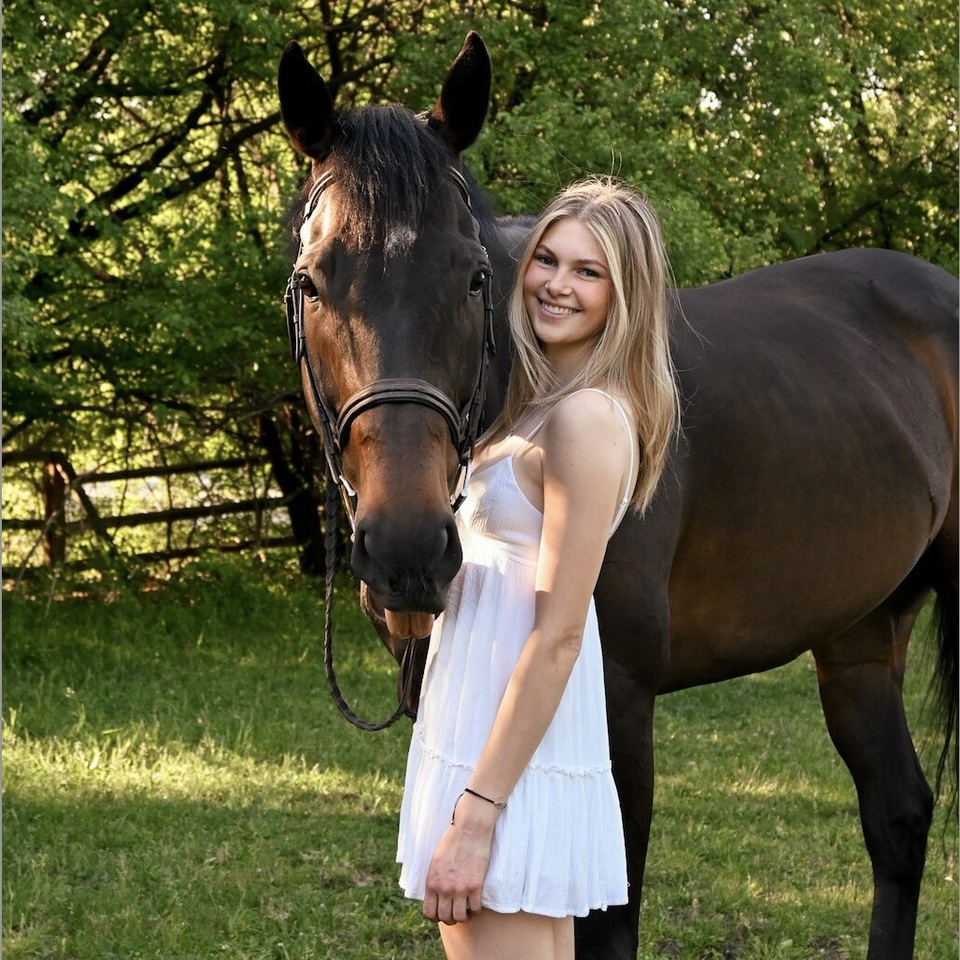 Abigail Giemza pictured standing beside her horse