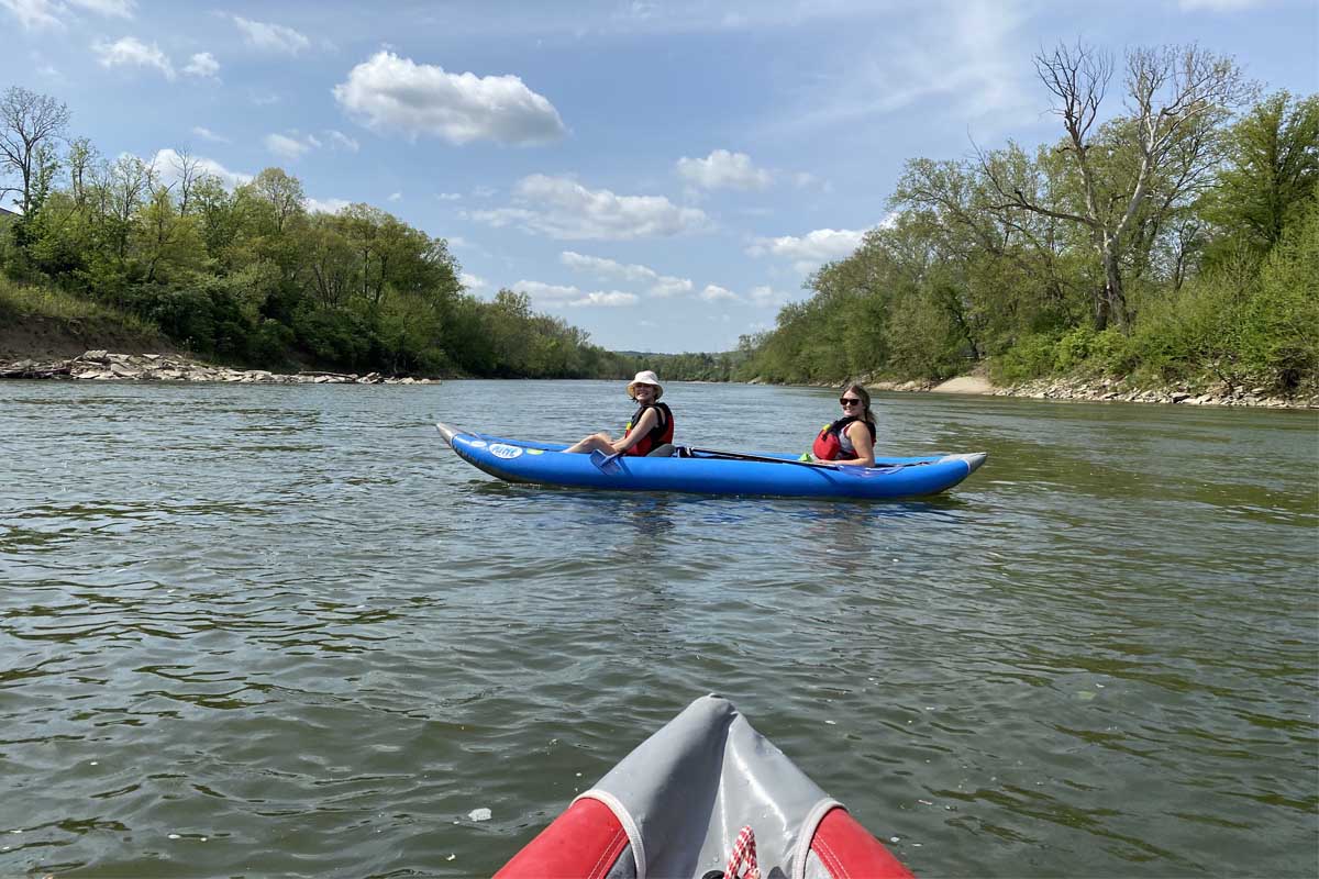 Miami students kayaking down a river