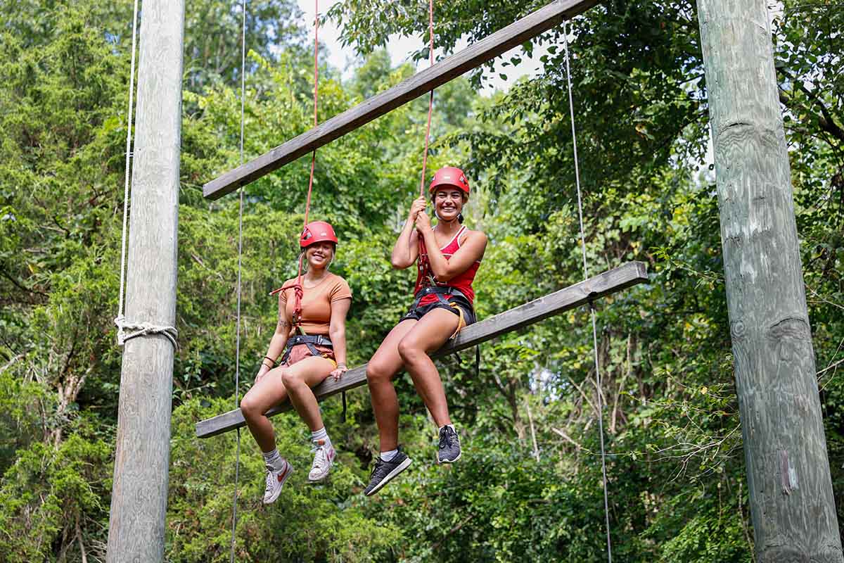 two participants sitting on wood plank