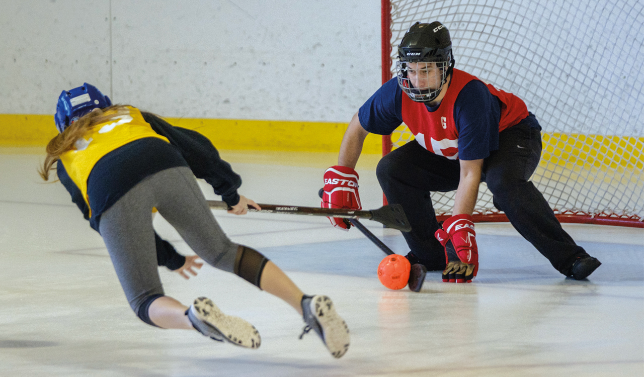 two students playing broomball