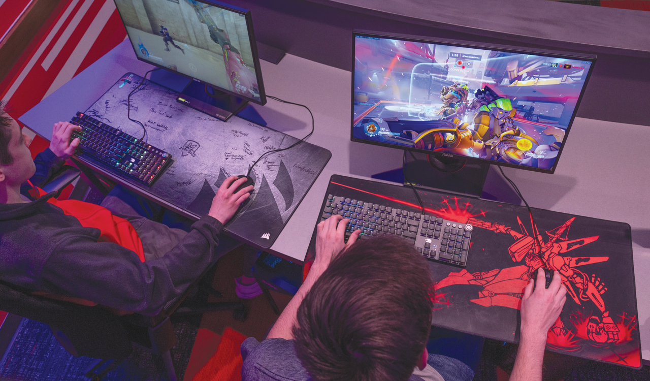 two students playing video games in the esports arena