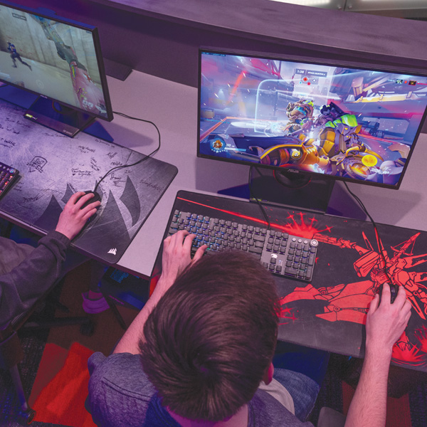 two students playing video games in the esports arena