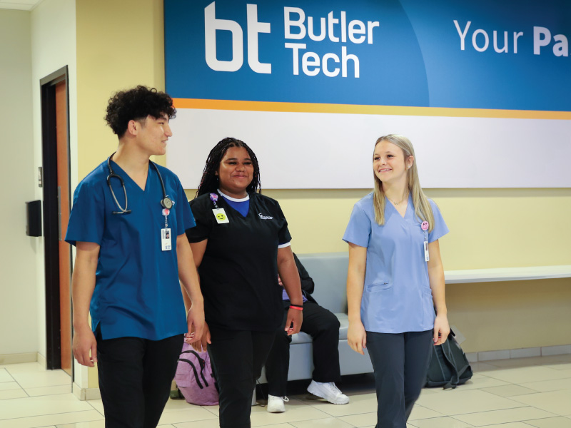 3 Butler Tech nursing students walking down a hallway