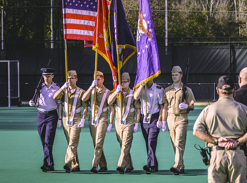 Miami ROTC students carry the flags during a ceremony.