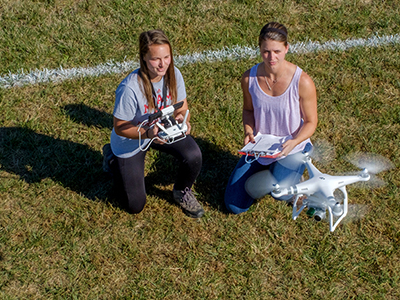 Christine Daley (left) and Aaryn Gray (right) use a drone to collect their data.