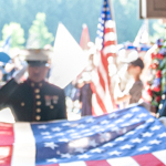 Soldiers carrying and saluting US flags