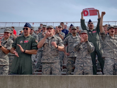 Enthusiastic cadets cheer on their team.