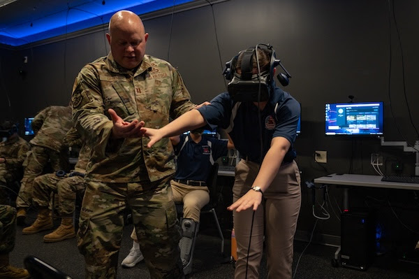Student with VR headset on is being guided by an instructor.