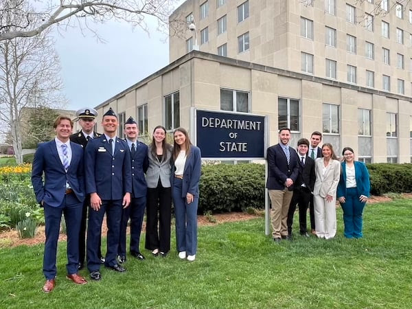 Group of students standing in front of Department of State sign.