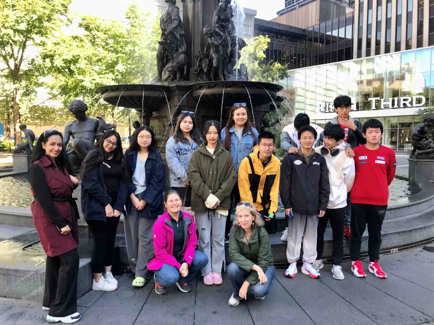 students in front of a fountain