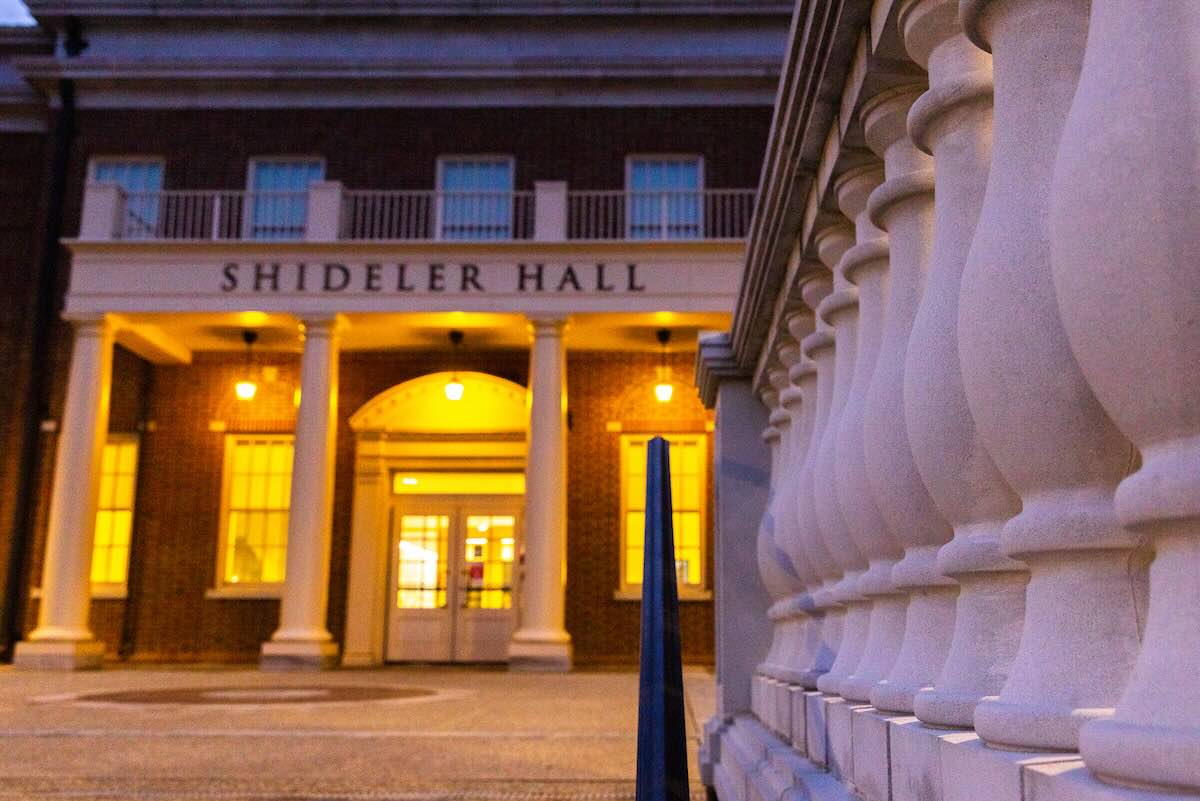 Up close of stone columns in front of shideler hall at night