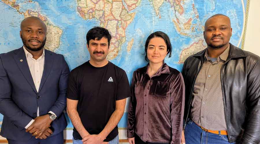 Four students who won the APA award stand together. 