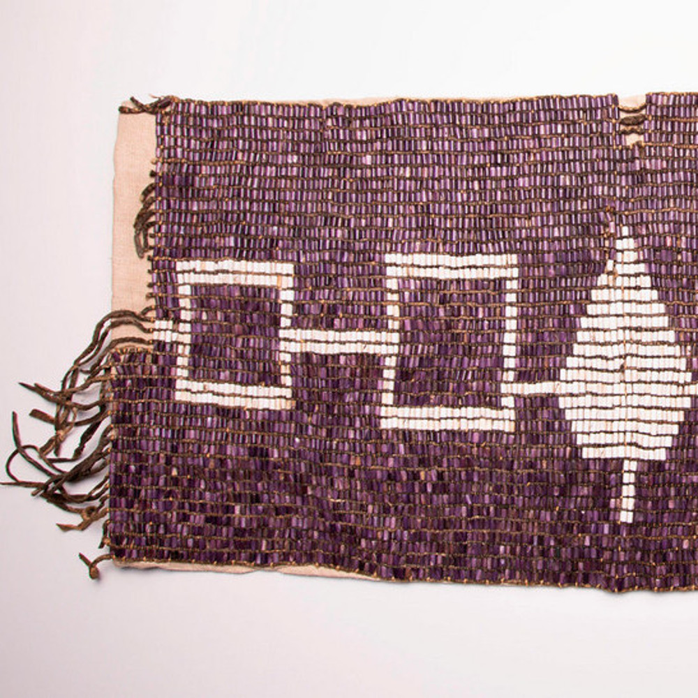 A wampum belt from the Onondaga Nation, the belt is made with purple and white beads.