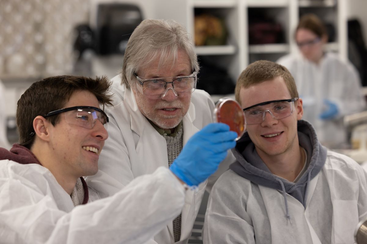 Dr. Carlin with two students conducting experiments