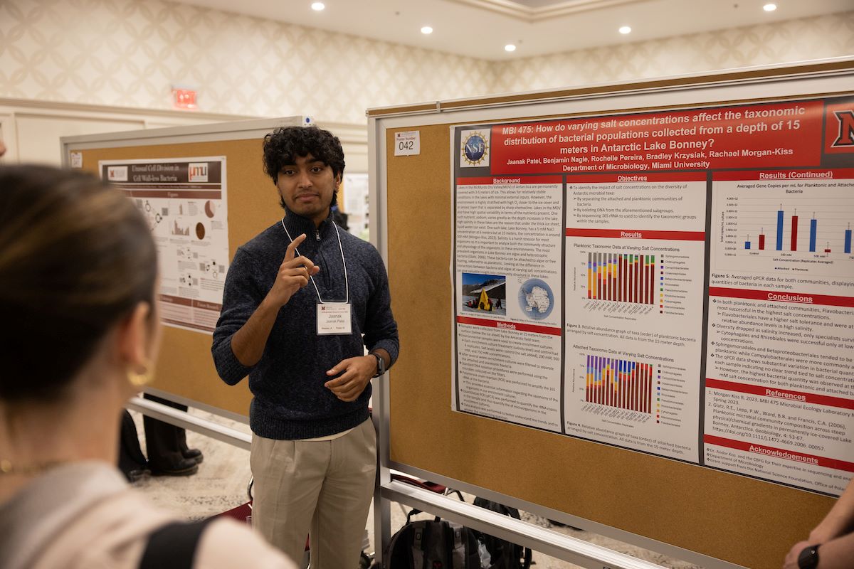 Student presenting in front of display