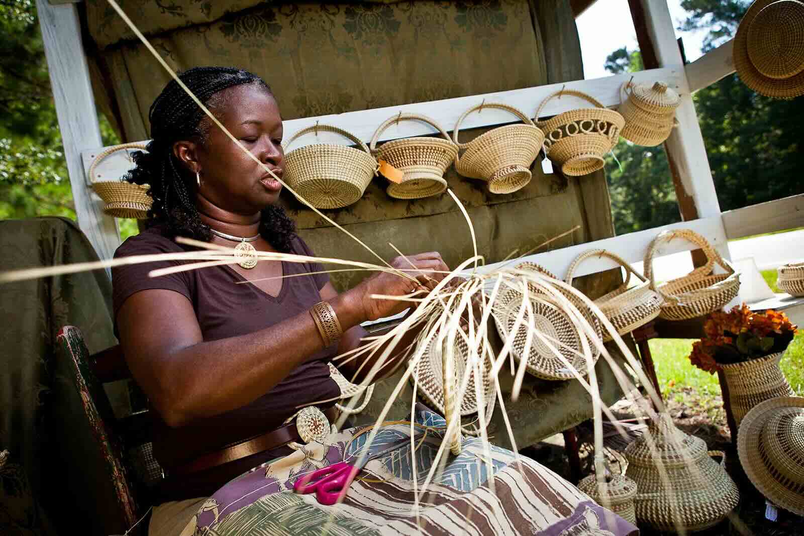 Gullah woman weaving sweetgrass basket