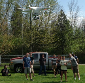 Students using drone in the field for mapping imagery