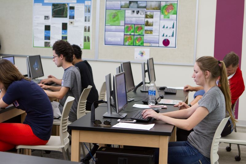 Students working on computers while working in a classroom