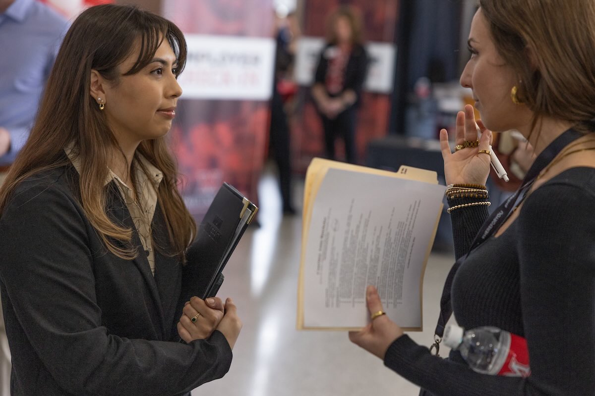 Student speaking to a representative during career fair