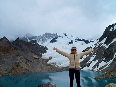 Rachael White lifts her arms to the heavens in beautiful Patagonia, Argentina.