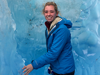 Rachael White stands alongside glacial ice in Patagonia, Argentina.