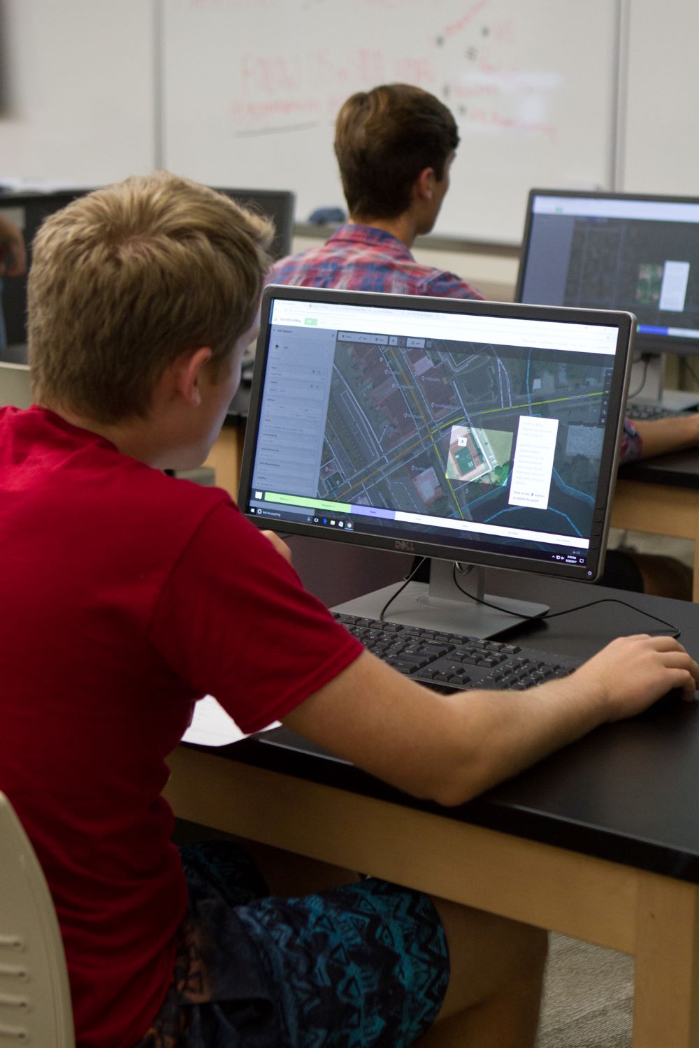 student in a classroom using a computer