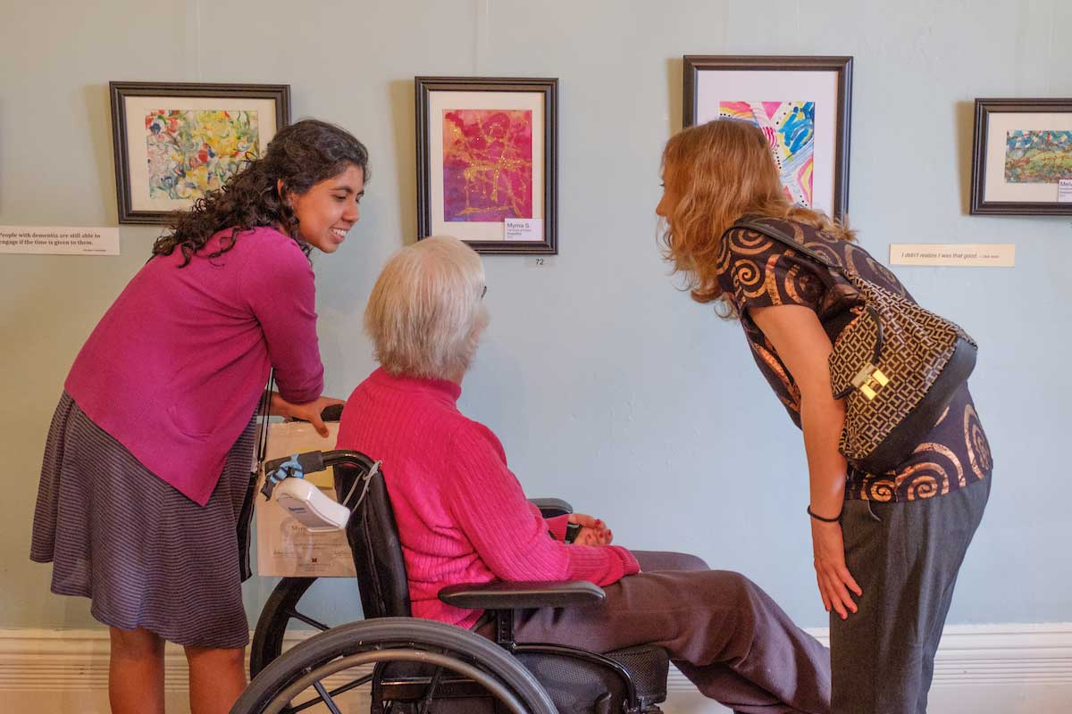 female student with elderly woman and her family