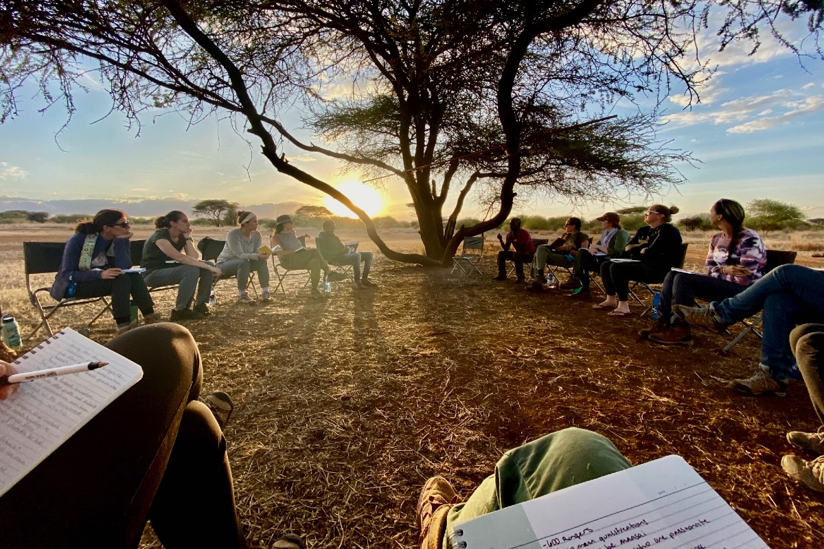 "Scout Rangers Peter, Wilson, and Saitabau sit with Miami University Project Dragonfly graduate students discussing the issues and connections surrounding human-wildlife conflict around the world."