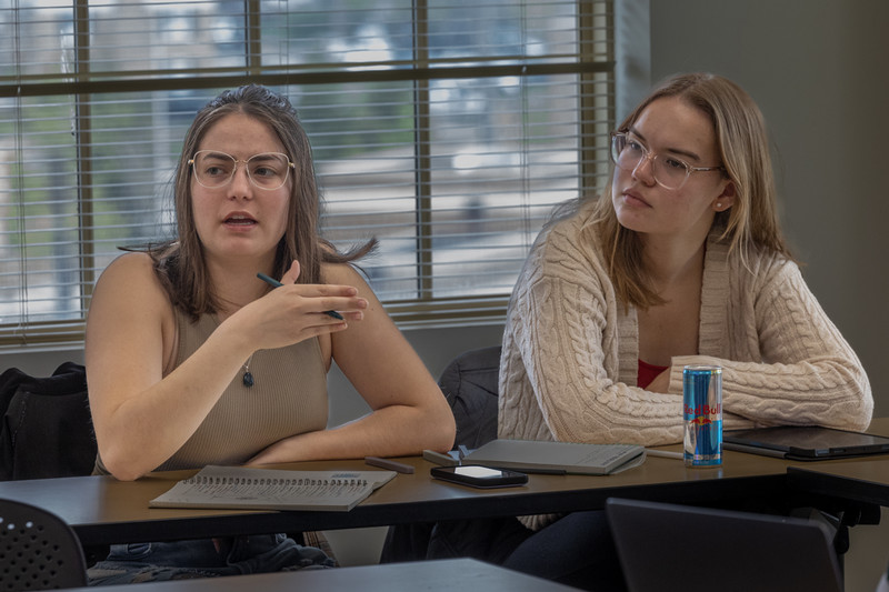 students around a table with professor