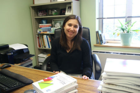 Jennifer Gibson sitting at a desk in her office.