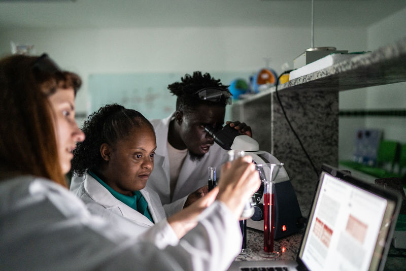 Students looking at a monitor in a lab