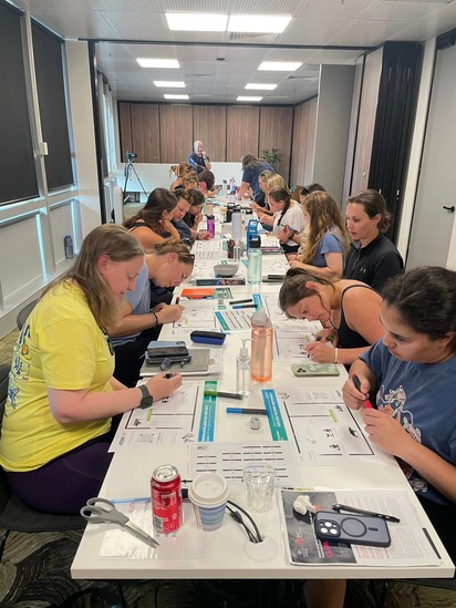 Students working together while seated at a table.