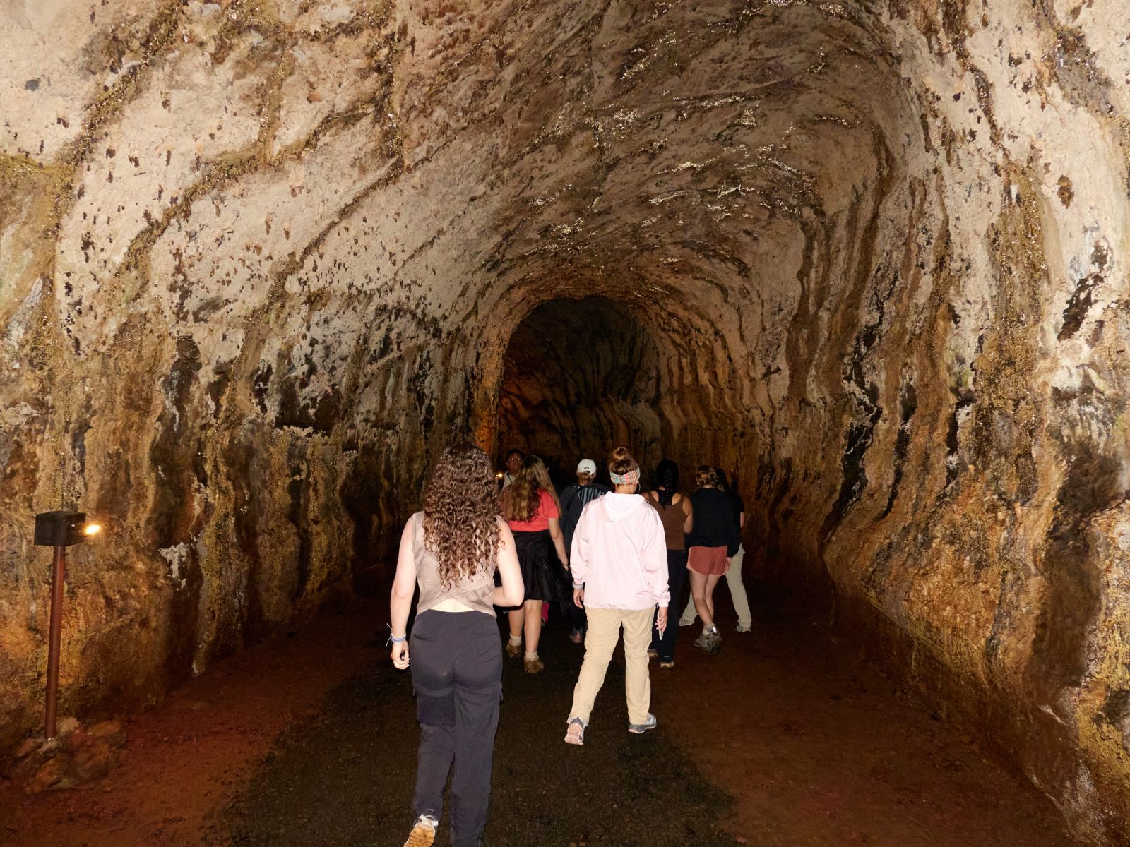 Students walking in a cave.