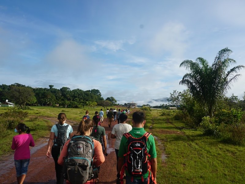 Students walking down a dirt path