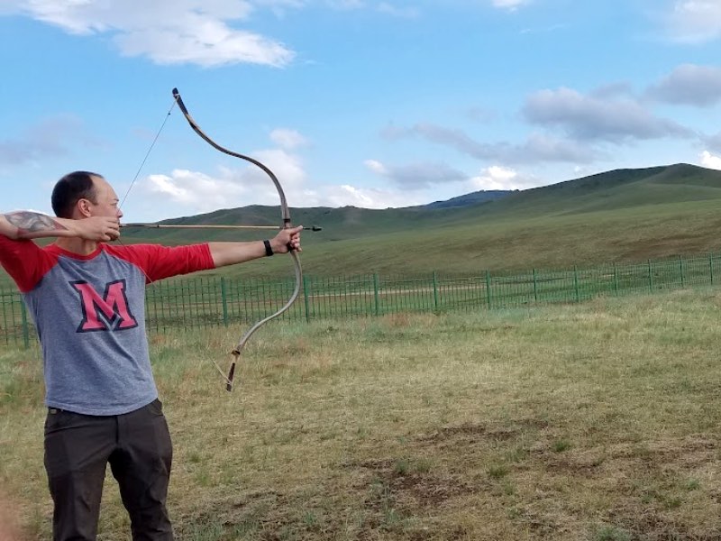 A student shooting a bow