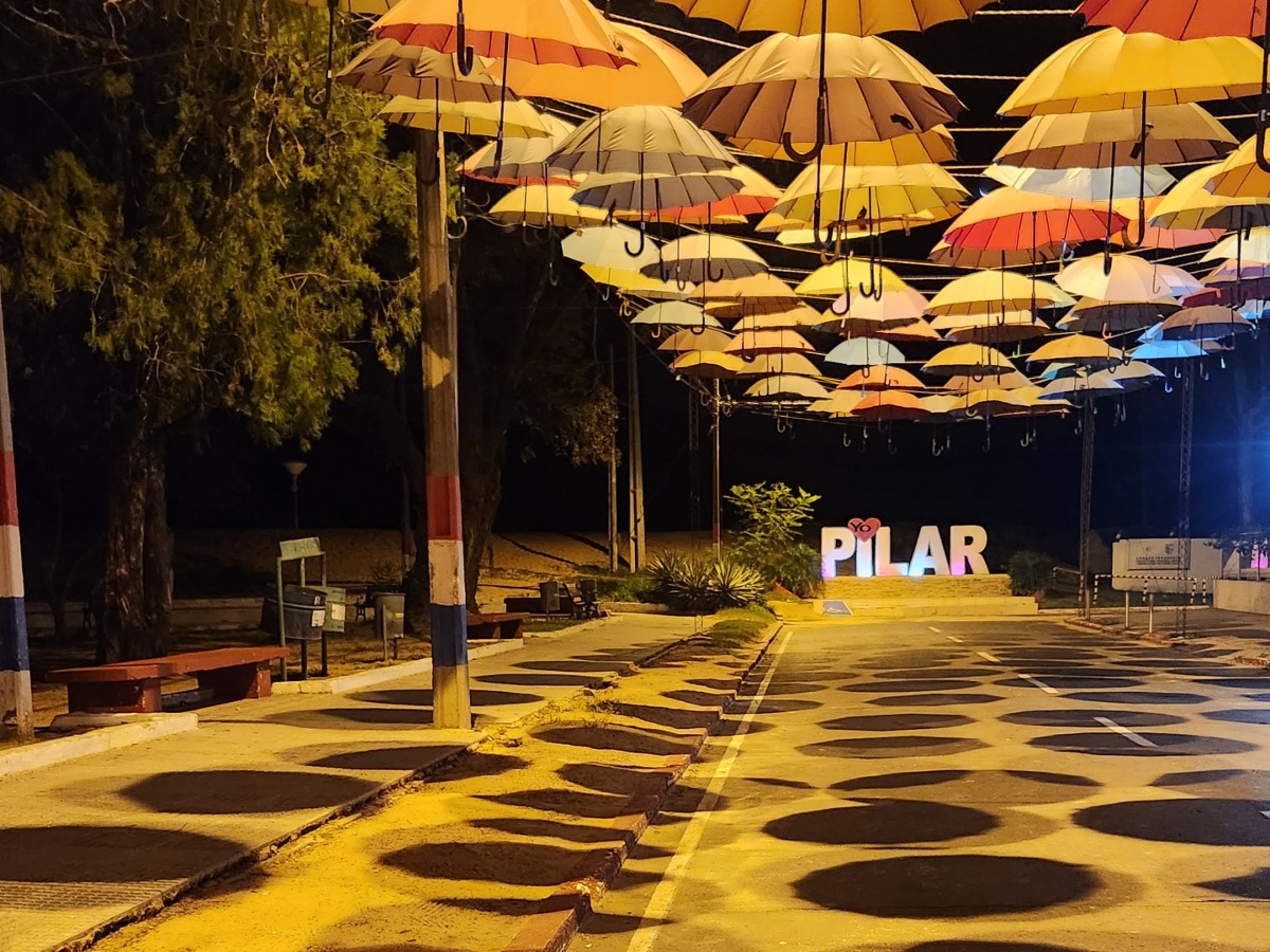 Umbrellas lit up on a walkway.