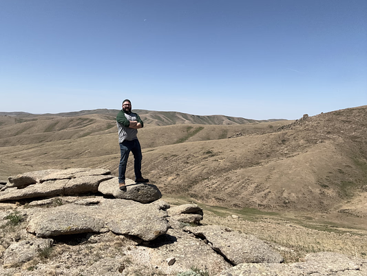 Dave Johnston standing on some rocks in Mongolia.