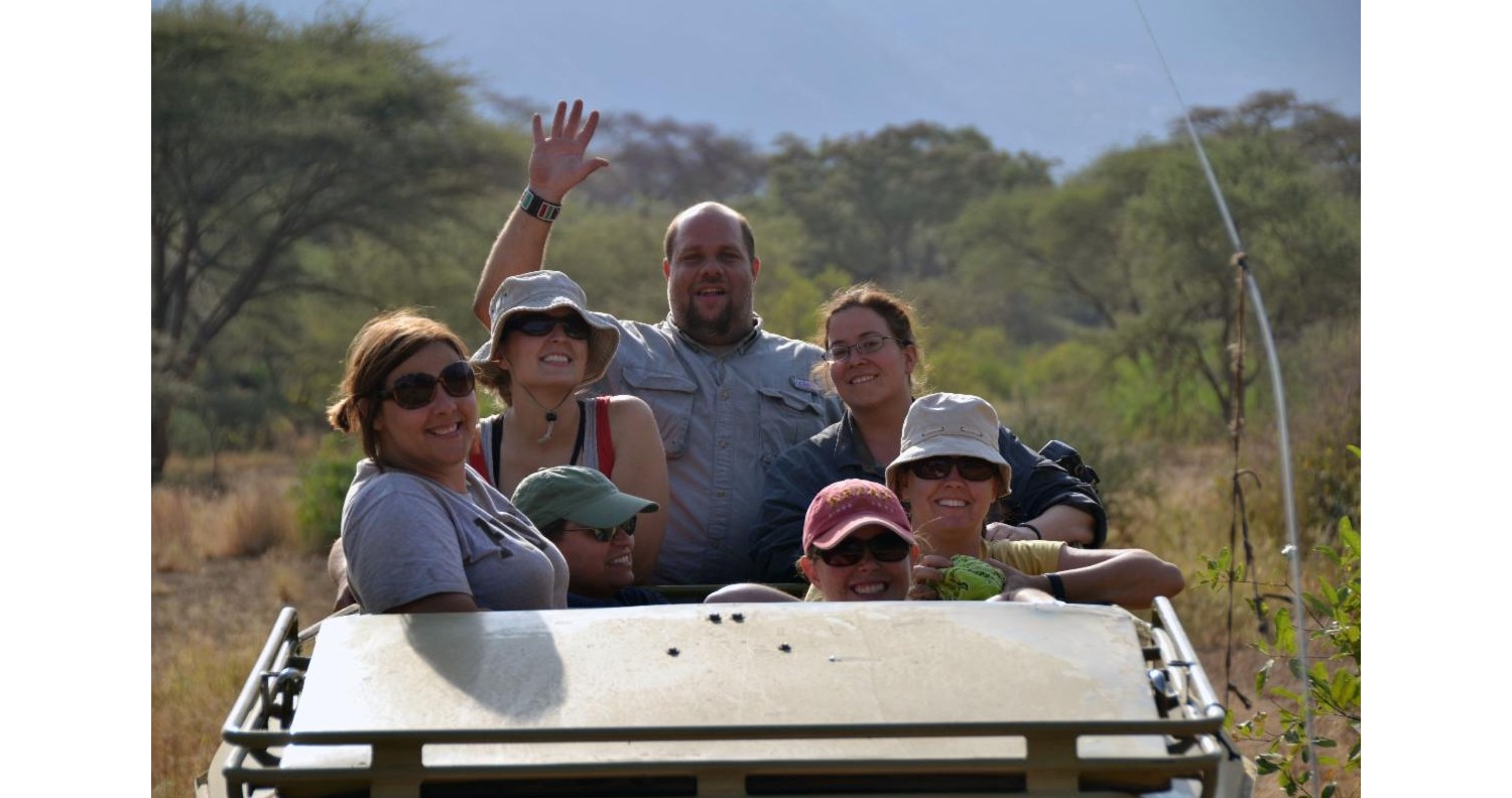 People in the back of a safari truck.