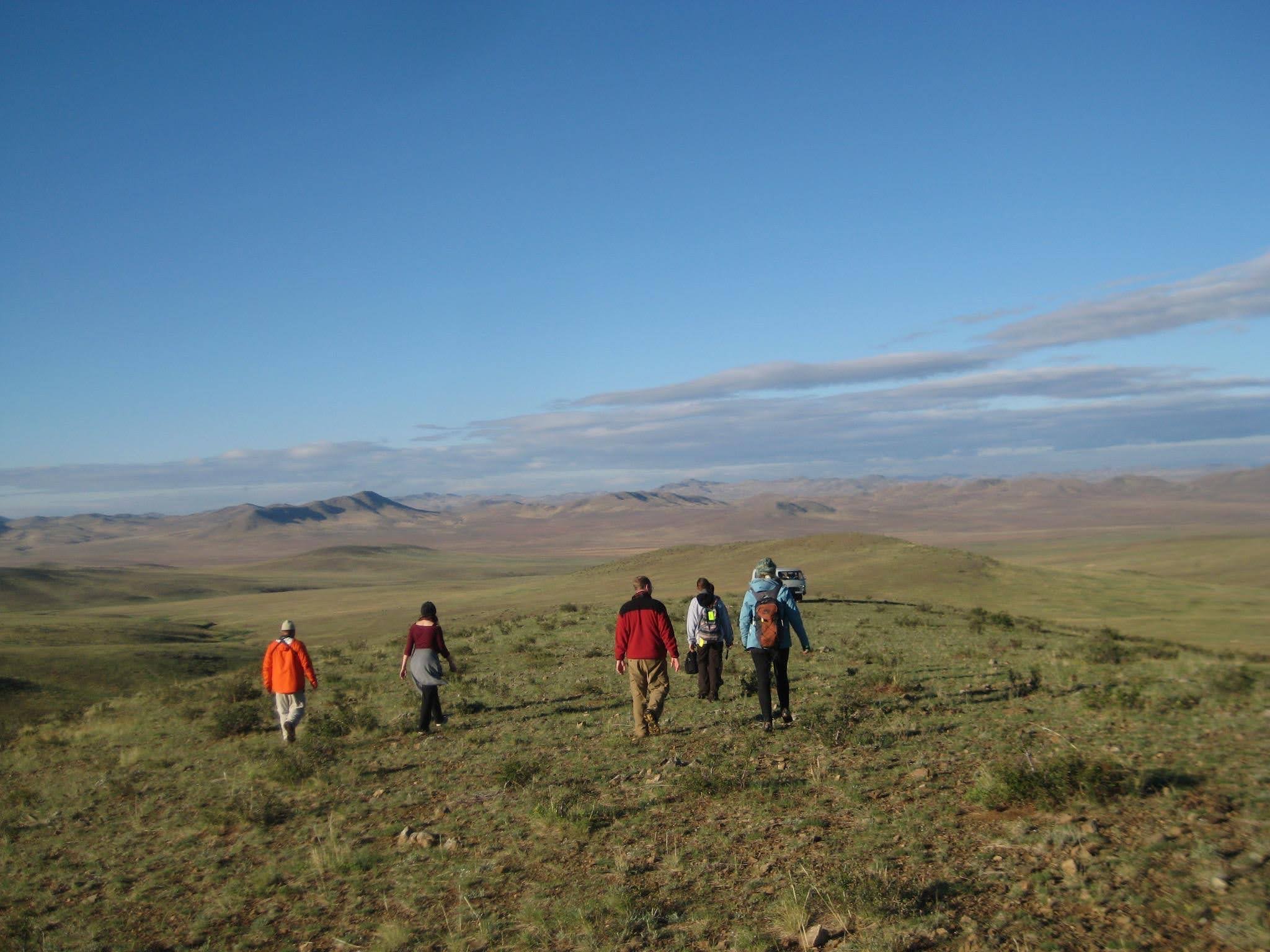 Students walking across the Mongolian landscape
