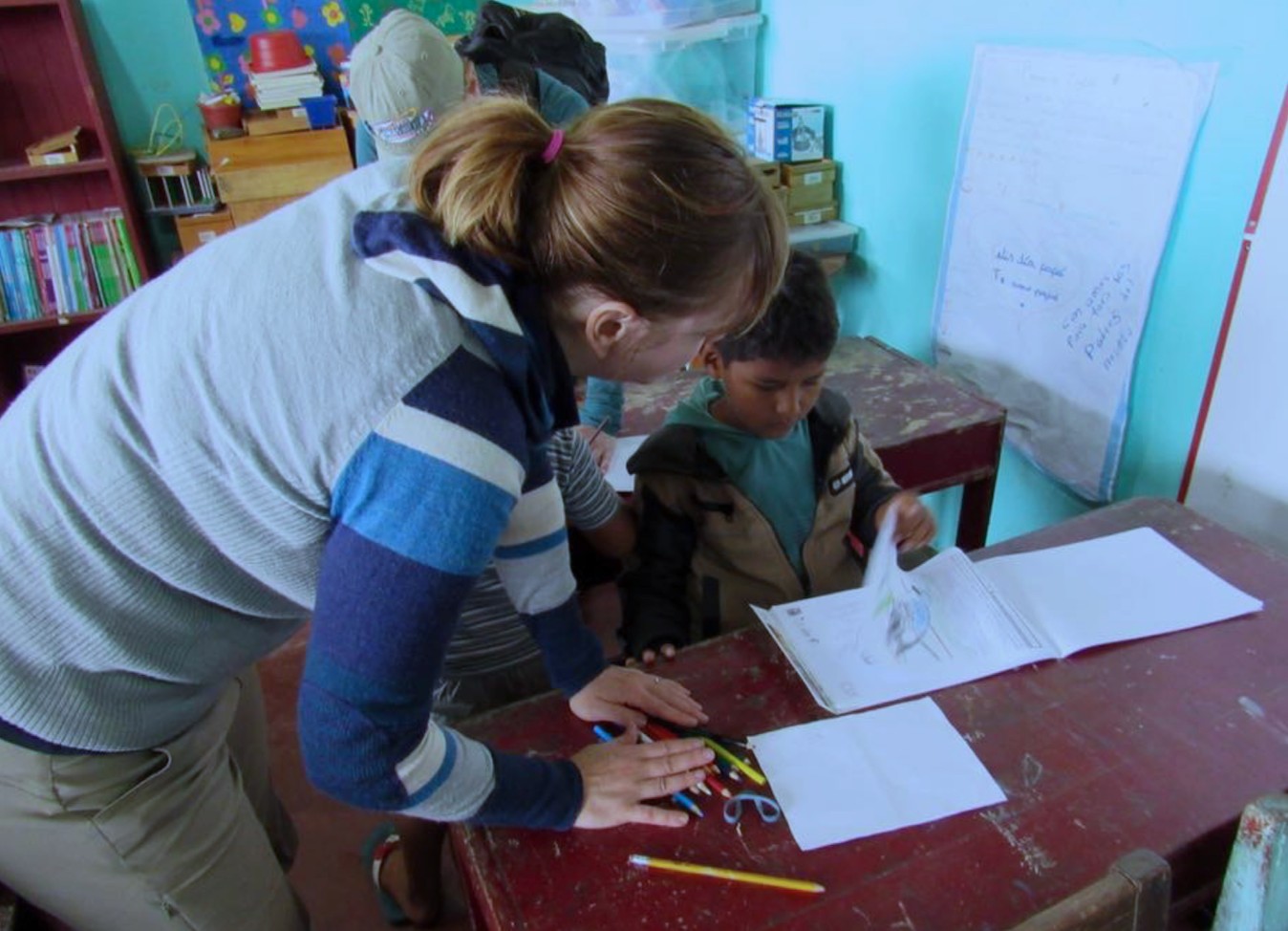 teacher helping a student