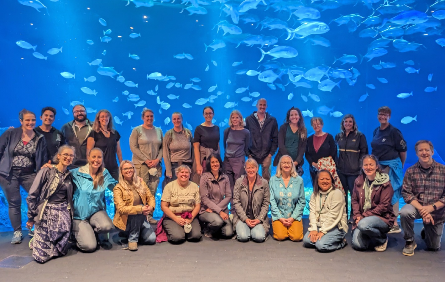 A group photo in front of an aquarium